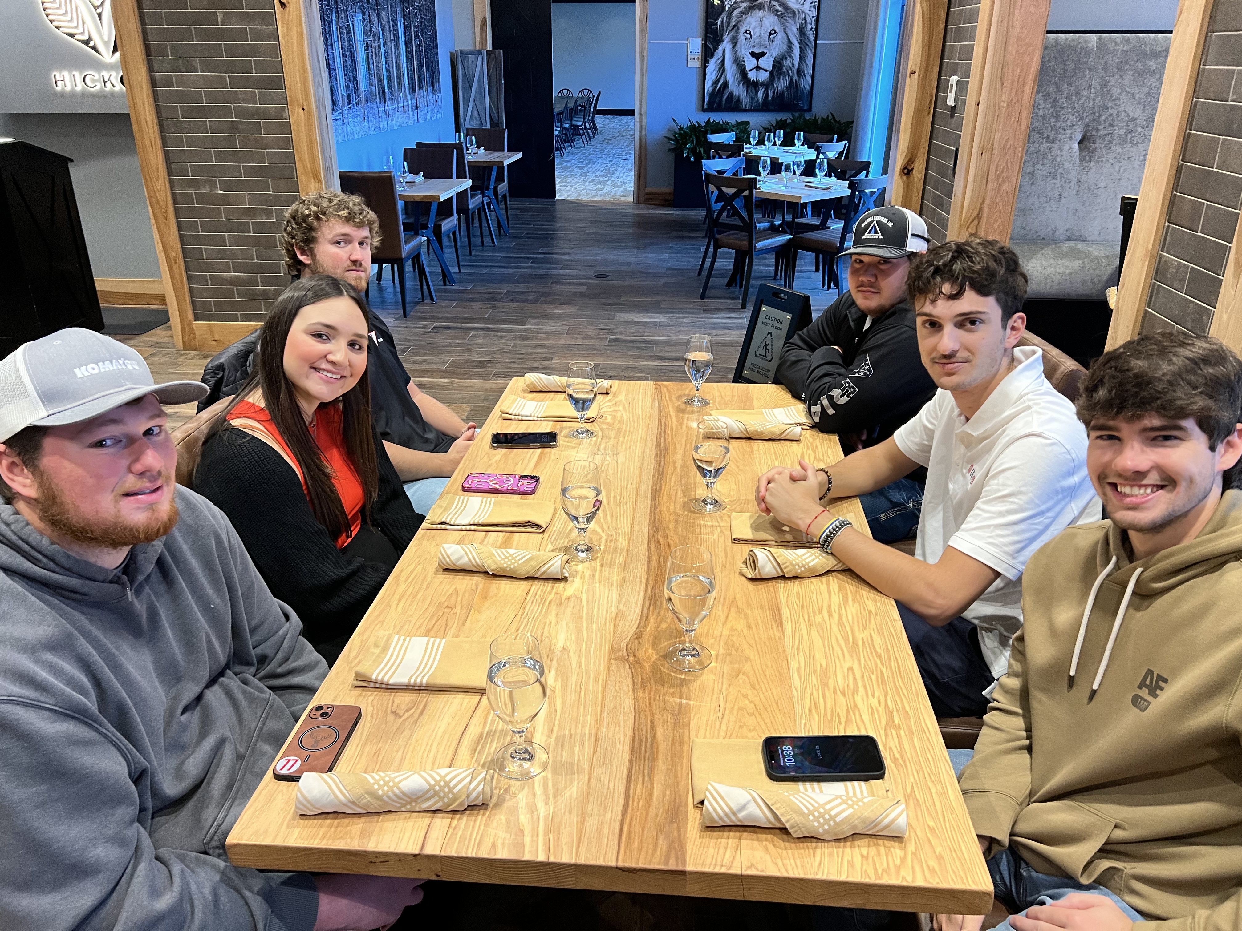 Students smiling while sitting at table