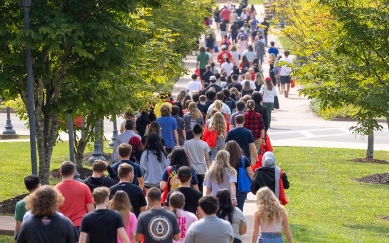 Students walking along campus sidewalk