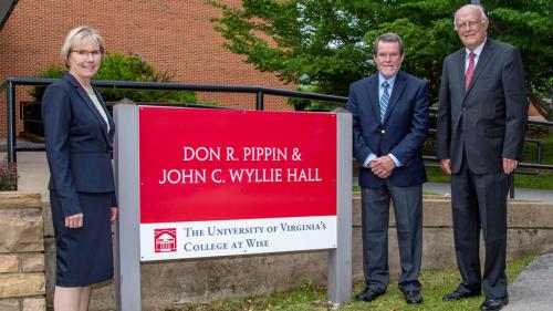 Chancellor Henry, Jeffrey Sturgill, Dr. Joseph Smiddy standing next to new sign.