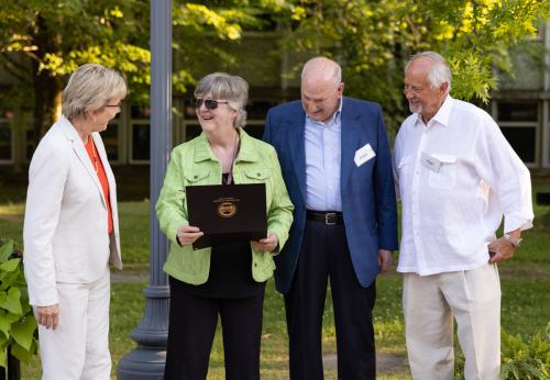 Chancellor Henry congratulates Professor Margie Tucker on her retirement along with board members Lewey Lee and Roger Viers.