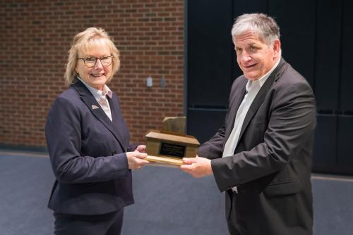 Chancellor Henry presenting Tom DePasquale with award