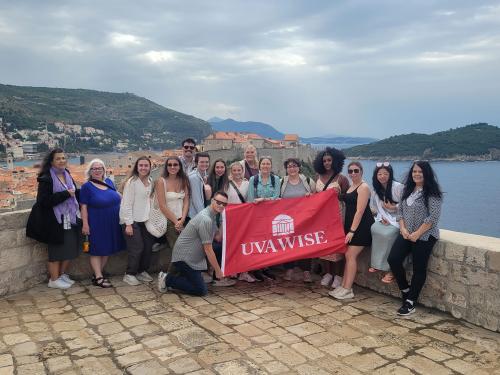 Group of students and faculty with UVA Wise flag