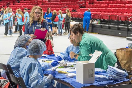 Students in scrubs seated at table