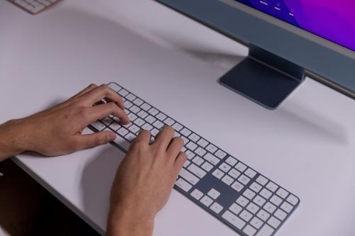 Hands typing on keyboard