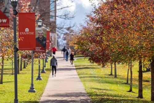 Students walking along sidewalk on campus