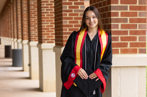 Girl smiling in graduation gown