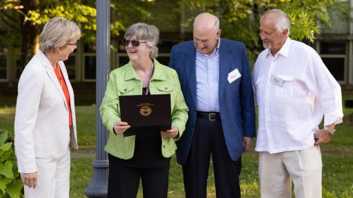 Chancellor Henry congratulates Professor Margie Tucker on her retirement along with board members Lewey Lee and Roger Viers.