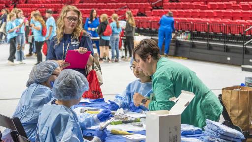 Students in scrubs seated at table