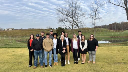 Group of students standing on land.