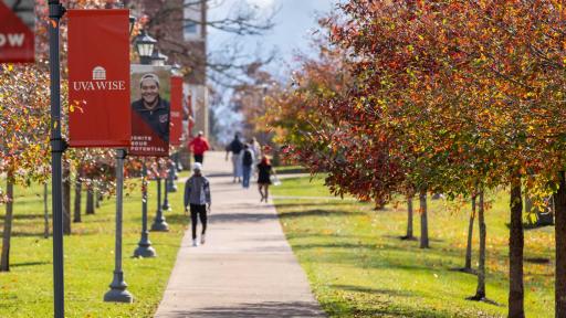 Students walking along sidewalk on campus